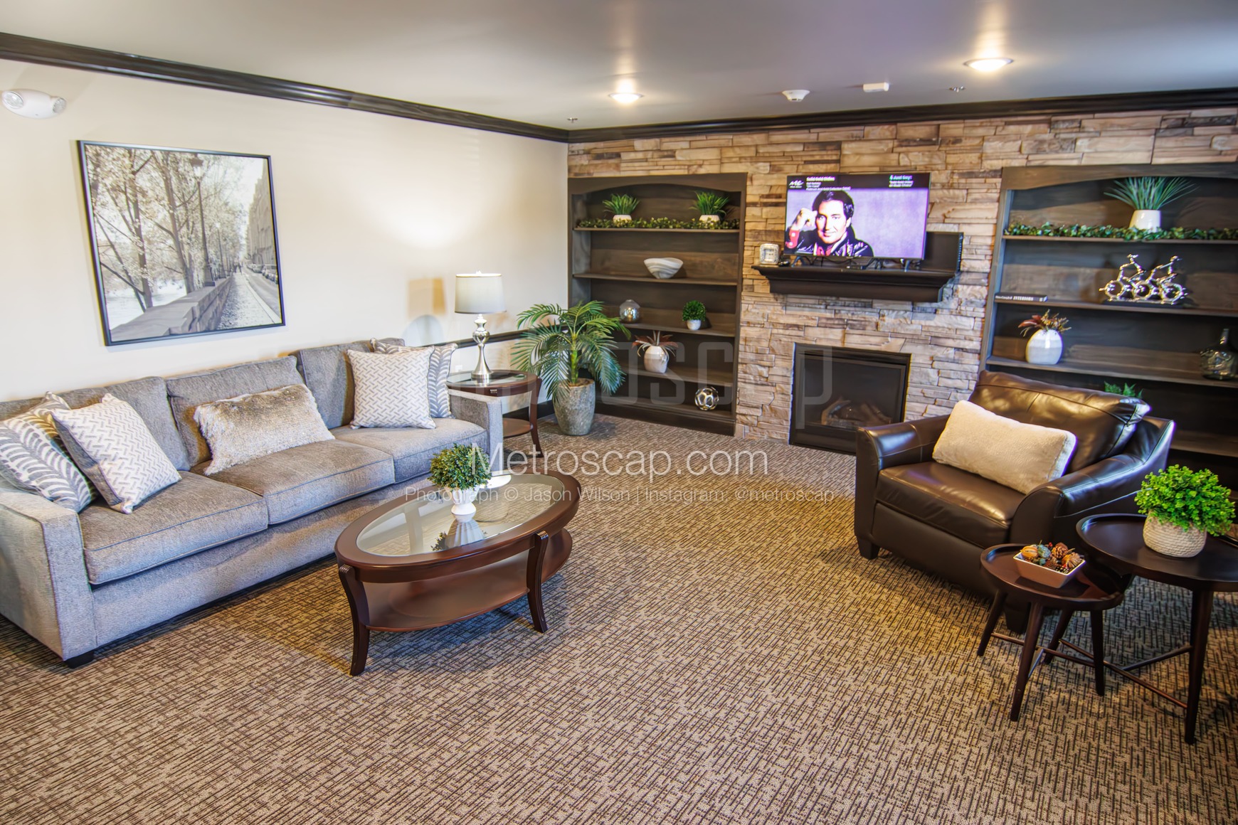 A living room with a fireplace and elegant, durable carpeting
